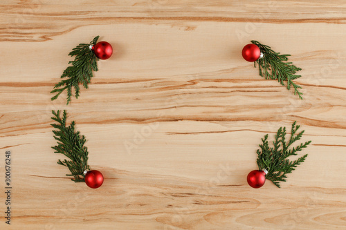 Flat background with wooden desk board top with christmas decorations and ornaments.