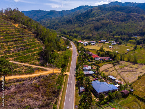 Beautiful Aerial image of rural landscape with beautiful young green paddy field in Tambunan, Sabah, Borneo photo