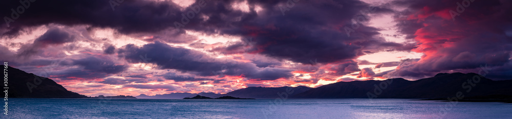 loch linnhe at sunset showing the ardnamurchan peninsula with golden and pink light on the clouds in october in the argyll region of the highlands of scotland