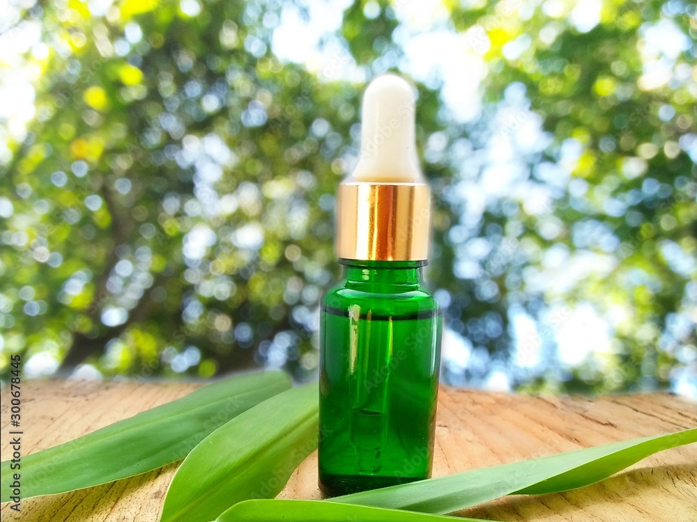 bottle of essential oil with flower bottle of essential oil with flower