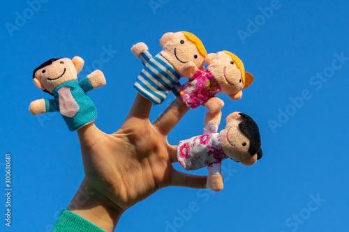 family finger dolls. child hand with finger puppets: son, daughter,mum, dad. Kid playing fingers puppets. Family and generation concept.