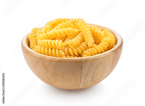 Pile of raw Macaroni (Gomiti Pasta) in wood bowl Isolated on white background photo