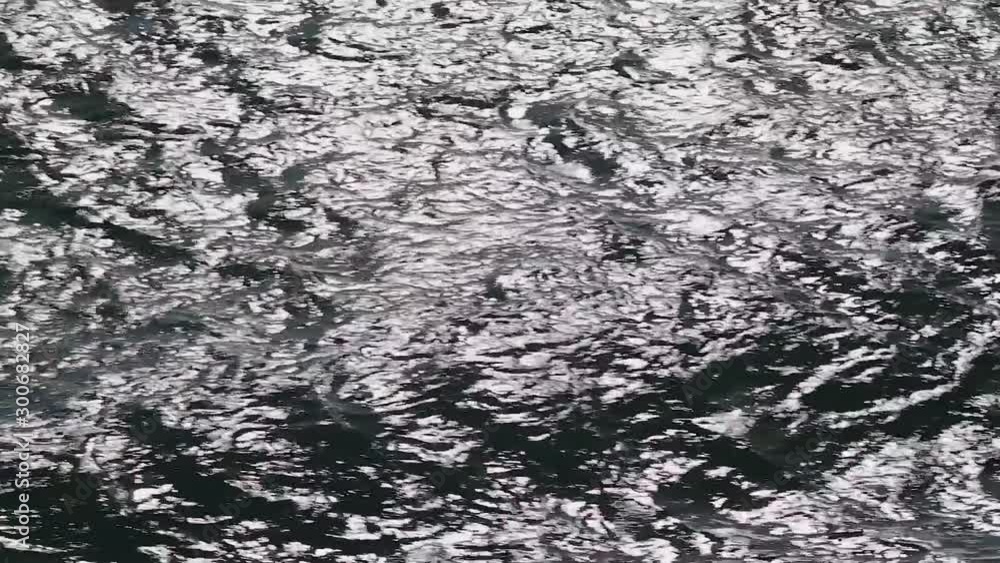 Dark, deep, ocean waves sparkling in bright sunlight moving across scene. Dark, deep, ocean waves sparkling in bright sunlight moving across scene.