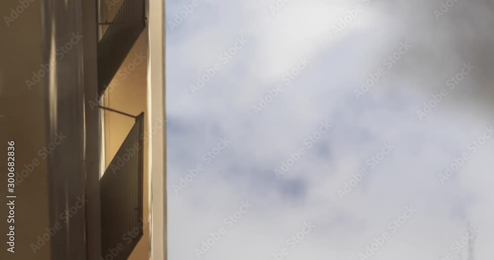 Looking at the reflection of a building and tree in a puddle which ripples after a storm Looking at the reflection of a building and tree in a puddle which ripples after a storm