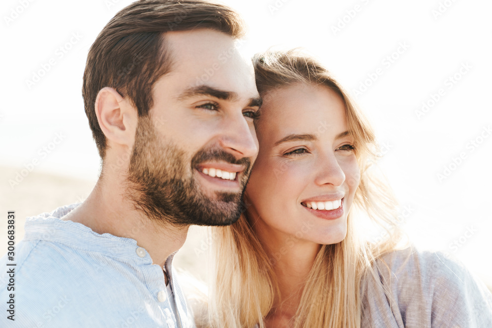 Close up of a beautiful smiling young couple hugging Close up of a beautiful smiling young couple hugging