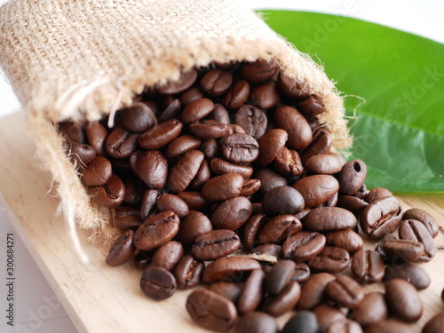 Close up macro coffee beans on woodrn plate