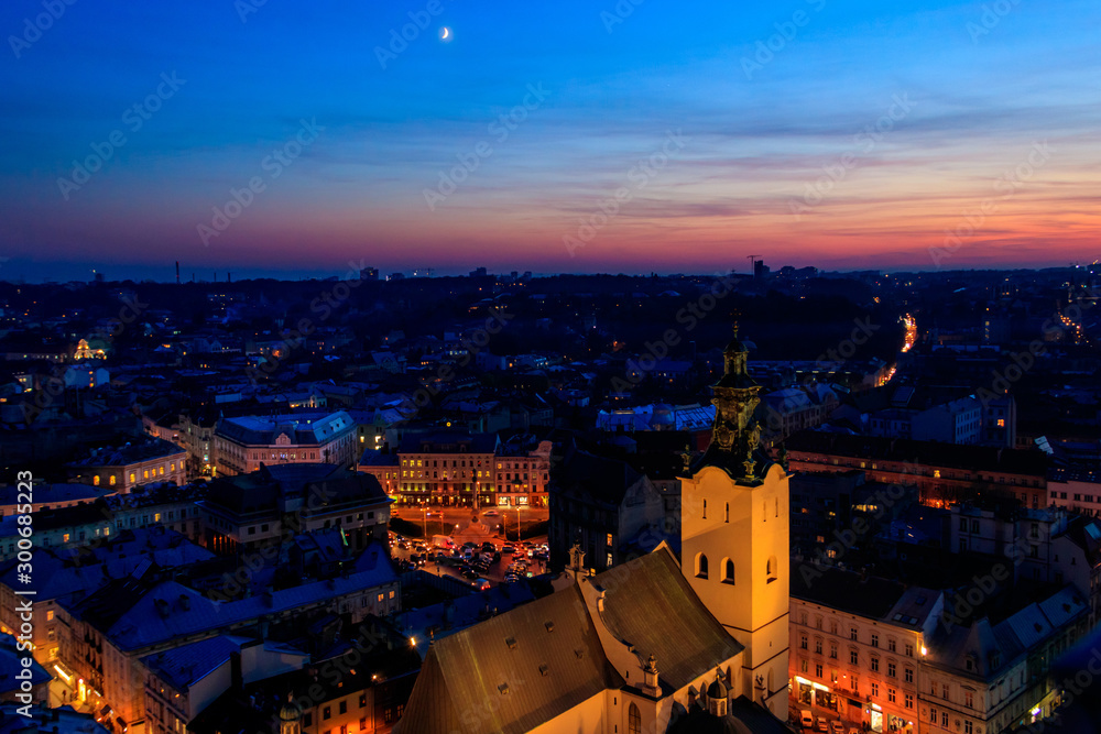 Aerial night view of illuminated Latin cathedral and Rynok square in Lviv, Ukraine. View from Lviv town hall