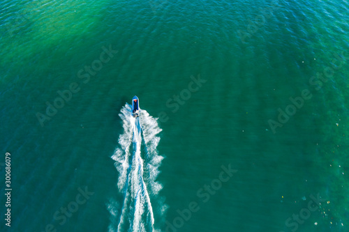 Aerial image of tourist speed boat on moving at clear blue sea at Waterfront Kota Kinabalu, Sabah, Malaysia