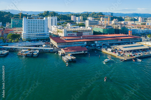 Kota Kinabalu cityscape aerial photo with fisherman boat parking at Waterfront Kota Kinabalu. Kota Kinabalu is the capital of Malaysia’s Sabah state.