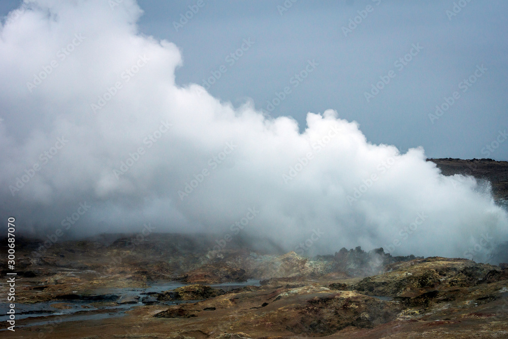Smoke from the ground in geothermal area in the icelandic countryside. Power, geology, natural and nature concept.