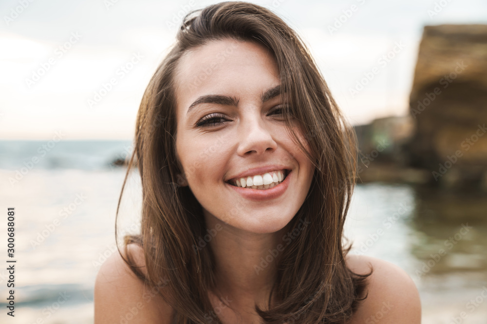 Image of happy caucasian woman smiling and looking at camera Image of happy caucasian woman smiling and looking at camera