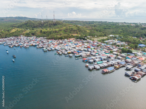Top down aerial view of the local lifestyle traditional water village houses in a small village Beside sea at Kudat, Sabah, Borneo.  © alenthien