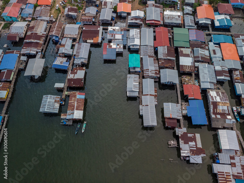 Top down aerial view of the local lifestyle traditional water village houses in a small village Beside sea at Kudat, Sabah, Borneo. 