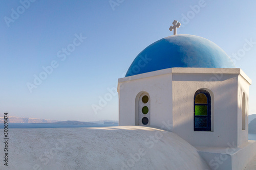 Blue roofed church dome in the islands of santorini in greece. Sunset, blue hour, colors, view, religion, architecture, building, travel, summer, holiday concept.
