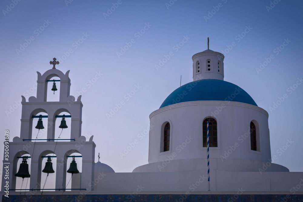 A church with blue roof in Santorini at night.
