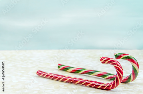 Christmas background. Two different Christmas candy canes, sleigh