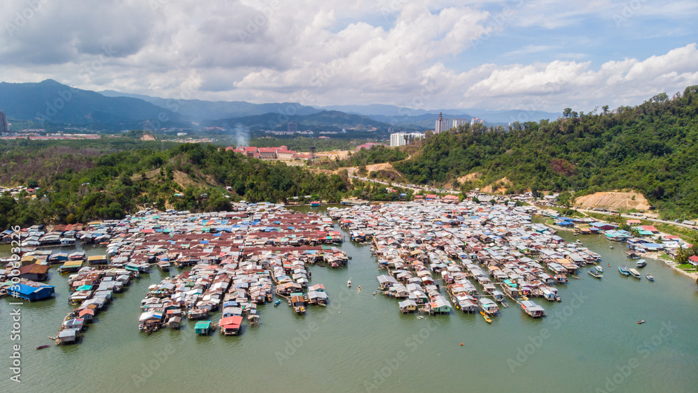 Top down aerial view of the water village houses in a small village Beside river at Sabah, Borneo