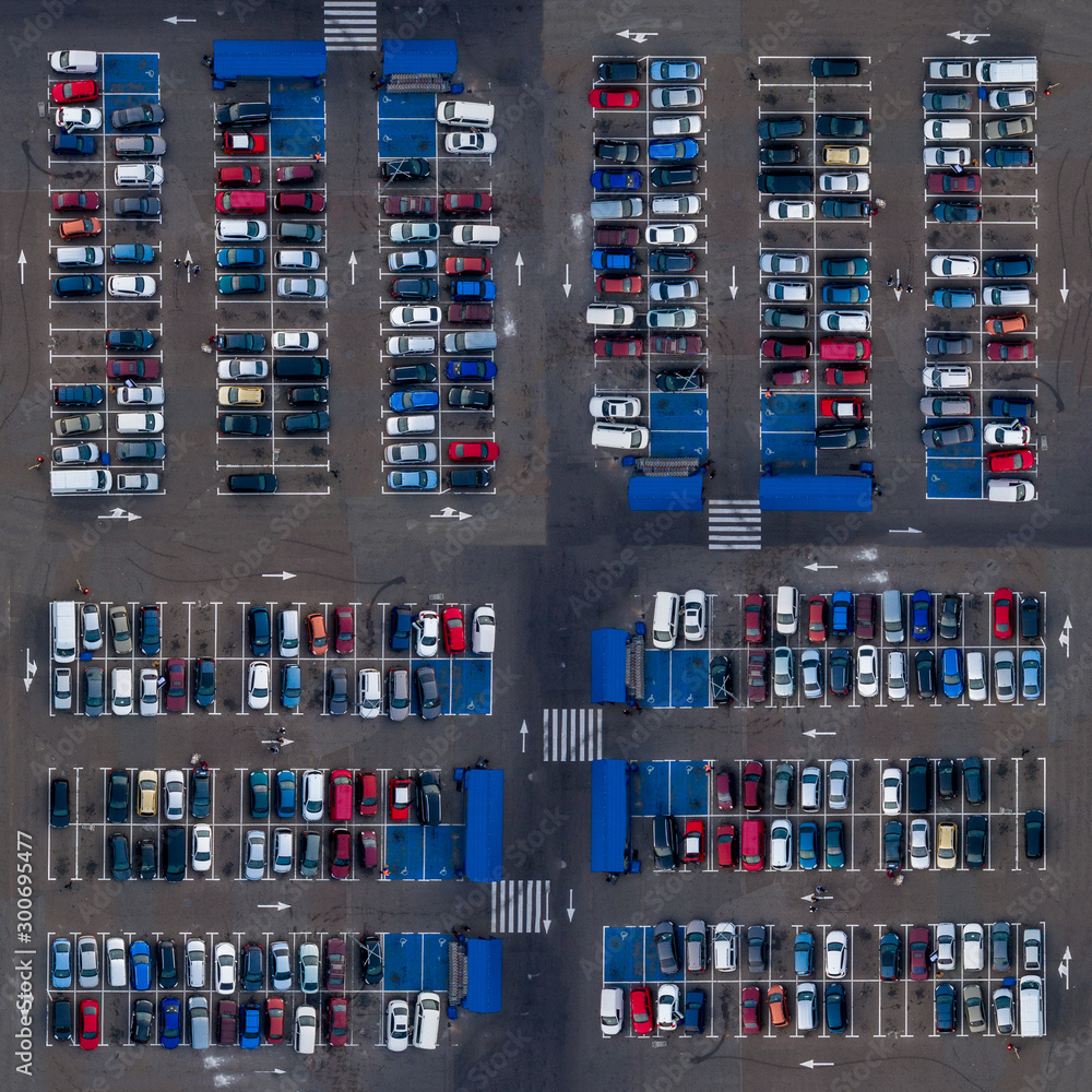 Square aerial top view parking lot cars. Parking lot top view cars are parked in open parking near market places.