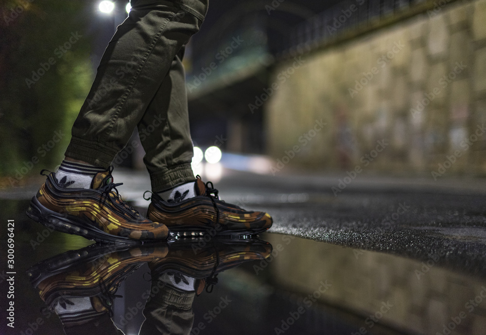 Foto Stock Man wearing Nike Air Max 97 Camouflage shoes | Adobe Stock