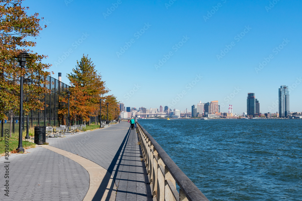 Walkway along the East River with Colorful Autumn Trees on the Lower East Side of New York City