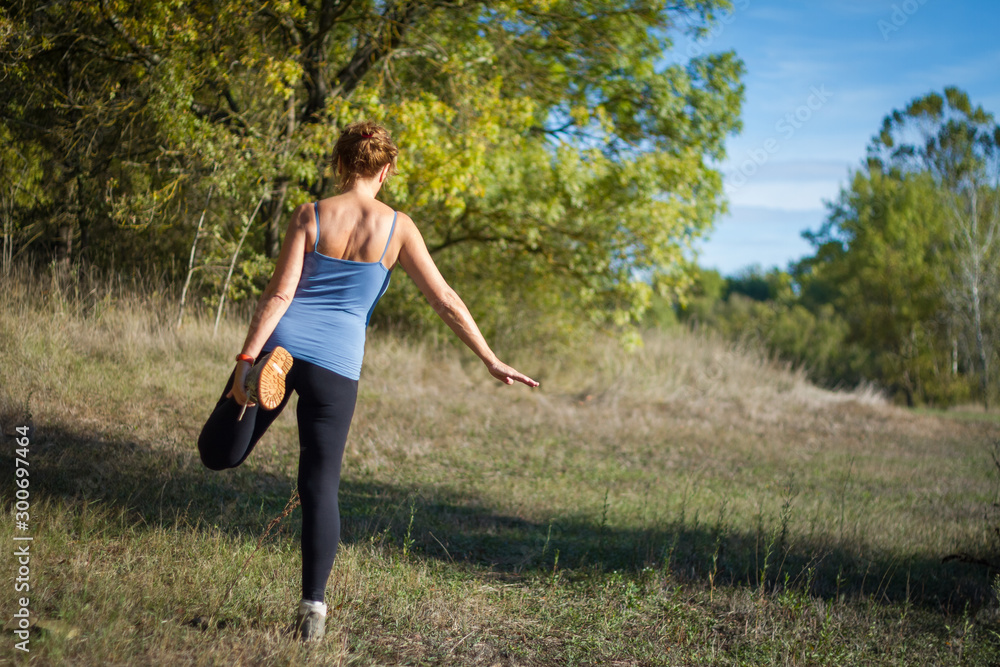 woman stretching legs on a sunny morning outdoors woman stretching legs on a sunny morning outdoors