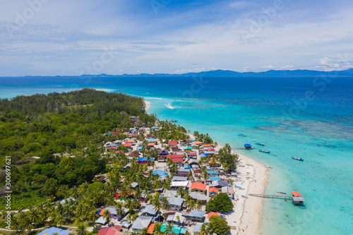 Aerial drone image of beautiful white sandy beach tropical island with turquoise sea water and Malay traditional fisherman village at Mantanani Island, Sabah, Borneo - Travel Concept © alenthien
