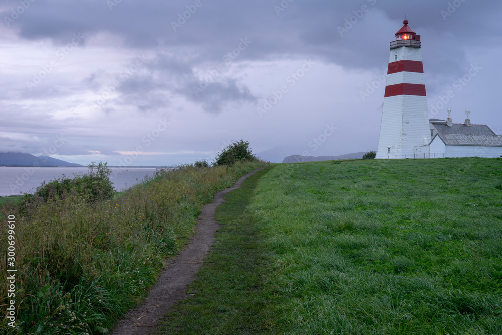 Lighthouse building and path in Aalesund/Norway. Summer, night, evening, holiday, vacation sunset, blue hour concept.
