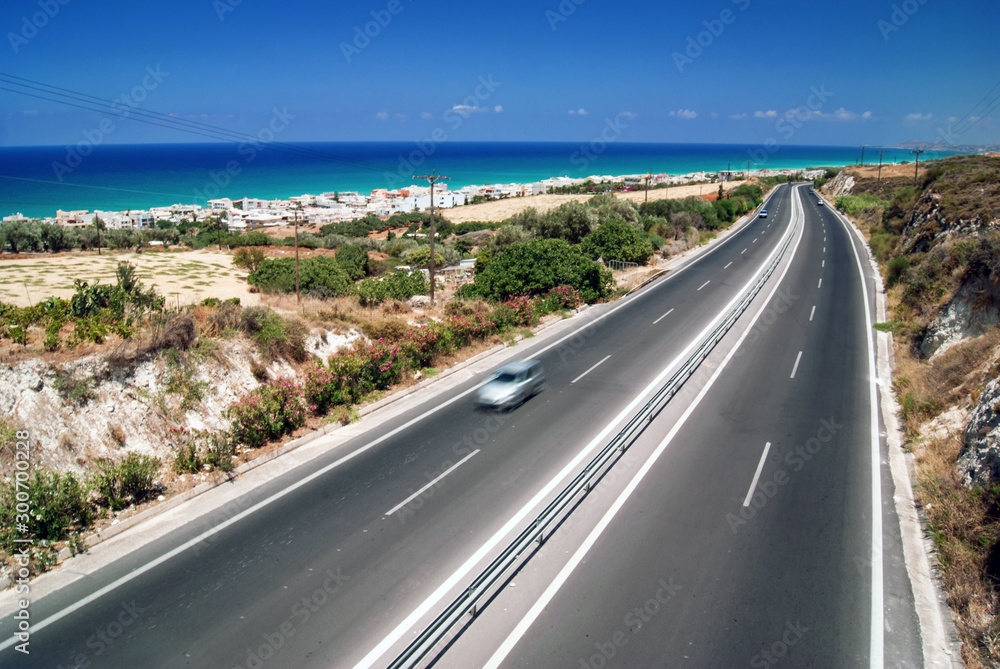 Highway in crete with beach and sea as background. Hoiday, summer, spring concepts.
