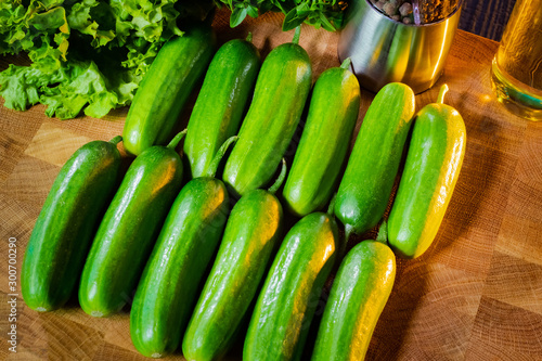 Cucumbers lie on a wooden B...