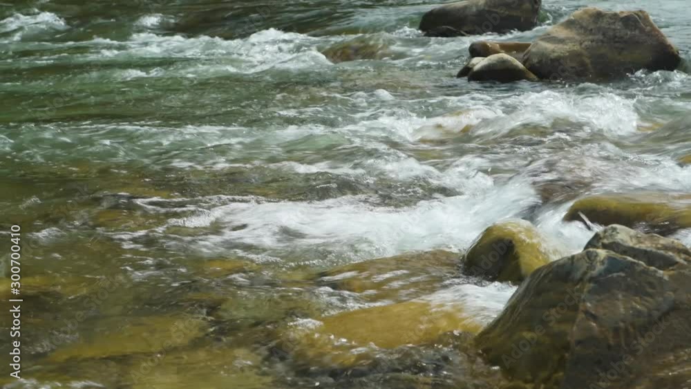 Closeup view of beautiful mountain river in summer day, Black Cheremosh, Ukraine. Fast flowing water and rocks Closeup view of beautiful mountain river in summer day, Black Cheremosh, Ukraine. Fast flowing water and rocks