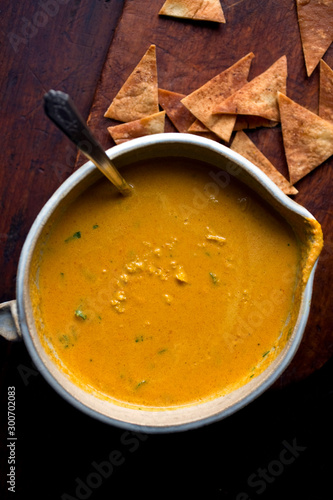 Lemon, carrot and tahini soup served in bowl with pita crisps
