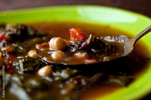 Close up of Valencian chickpea and chard soup served in bowl