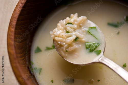 Close up of egg lemon soup served in bowl