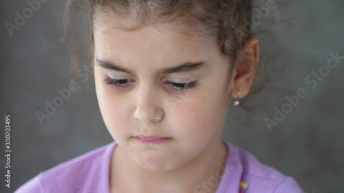 The hands of an adult pull the thread tied to the child's tooth. Successful attempt to remove a tooth. Pull out the tooth with a thread. Remove the tooth at home. Portrait