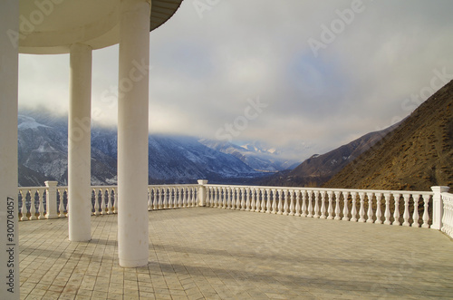 Triumphal rotunda of Sharvili with terrace and balustrade. Scenic view of dramatic sky and mountain range spur. Sharvili - hero of the Lezghin epos. Nature and travel. Russia, North Caucasus, Dagestan photo