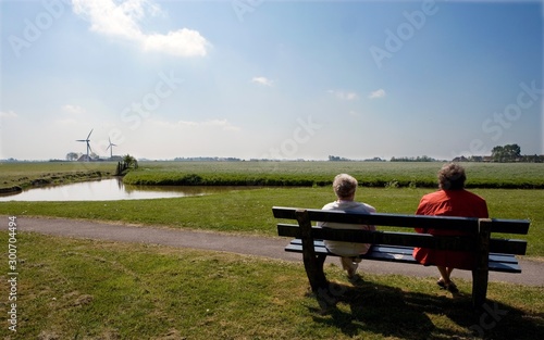 Old couple sitting on bench. Friesland Netherlands