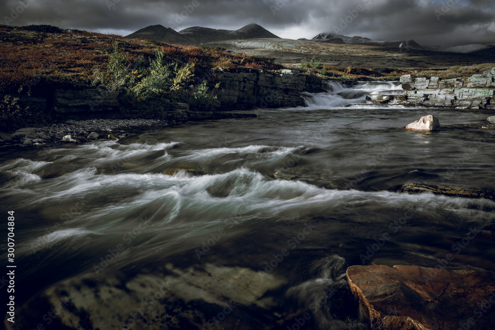 River stream and mountain scenery in autumn colors.