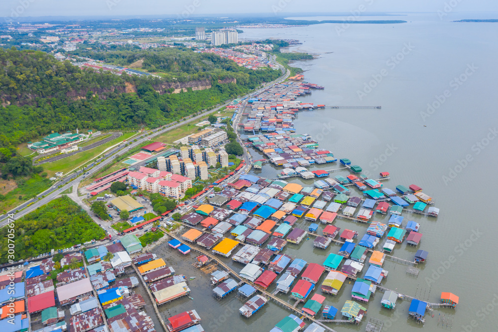 An aerial image of local water village houses at Kg. Sim Sim water village Sandakan City, Sabah, Malaysia. Sandakan once known as Little Hong Kong of Borneo.