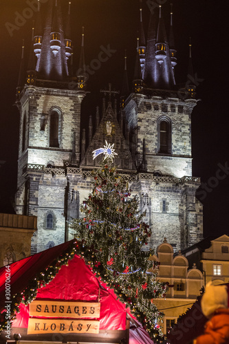 Tyn Square with Christmas market and decorated Christmas tree. Old Town Square, Prague.  Christmas concept. (image traslation: sausages) photo