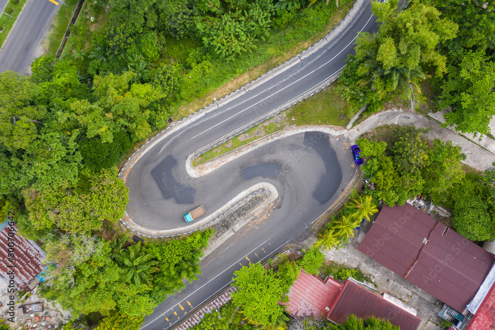 Asphalt road curve on high mountain image by Drone bird's eye view.