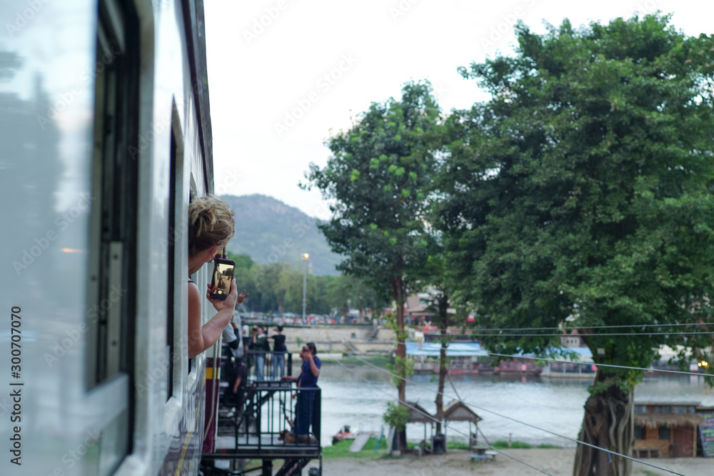 Fototapeta premium Blurred motion picture of female traveller records clip during train trip in Thailand