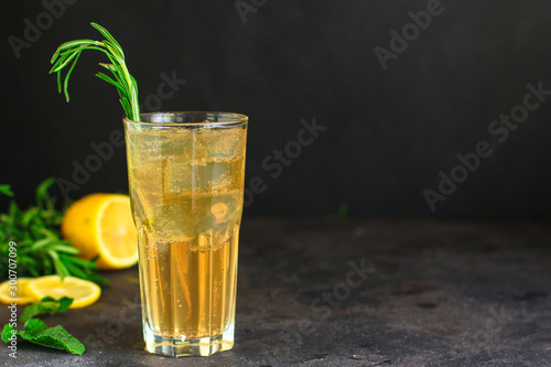 lemonade ice in a glass with rosemary (tasty drink, beverage) menu concept. food background. top view. copy space