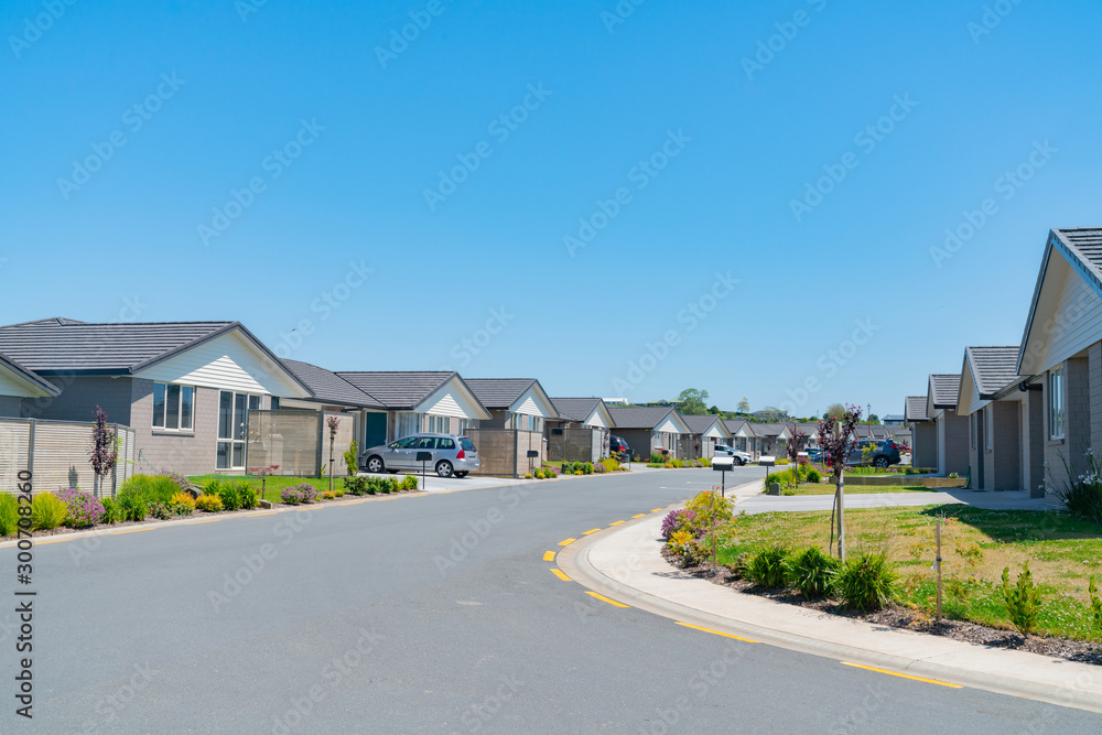 New subdivision street with uniform homes. New subdivision street with uniform homes.