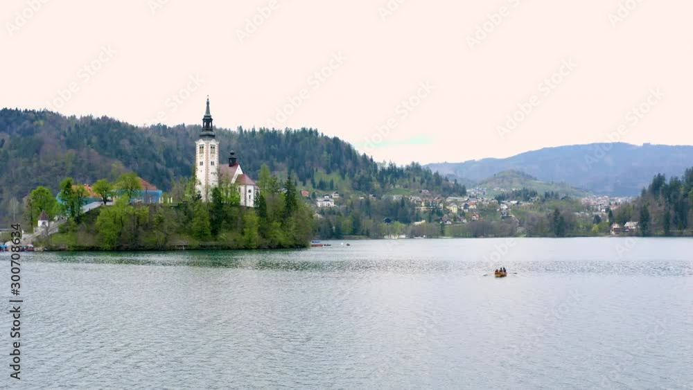 An island in the middle of a lake. The church is standing in the middle of an island. An island in the middle of a lake. The church is standing in the middle of an island.