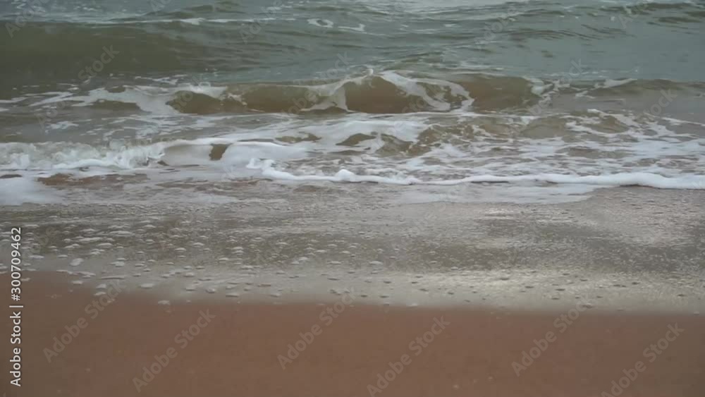 Storm at sea. The coast of the Sea of Azov in stormy weather. Waves, wind and spray of the sea. Russia Storm at sea. The coast of the Sea of Azov in stormy weather. Waves, wind and spray of the sea. Russia