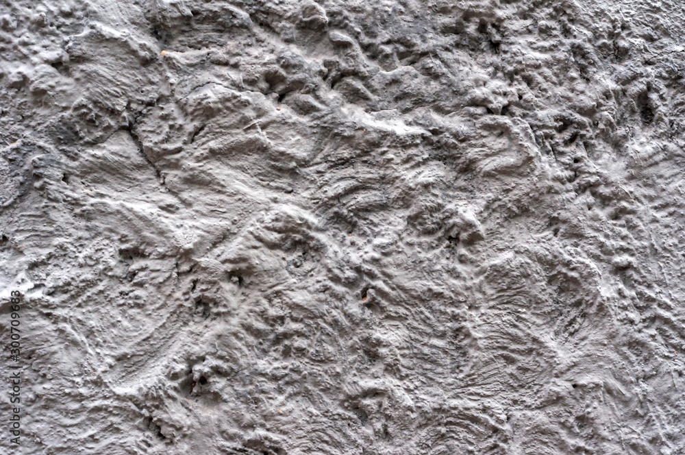 Obraz premium Rough dark gray relief plastered wall. Blank texture, background, blank for designers