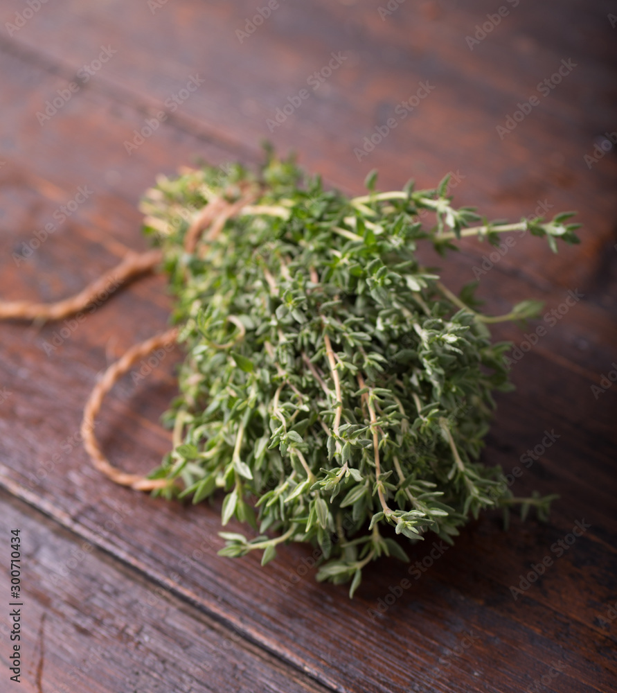 Bunch of garden thyme herb on wooden table Bunch of garden thyme herb on wooden table