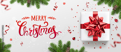 Merry Christmas card with holiday text, gift boxes, fir branches, red ribbons and bow, sparkles, confetti, bokeh on light background. Xmas and New Year holiday. Vector Illustration, realistic vector
