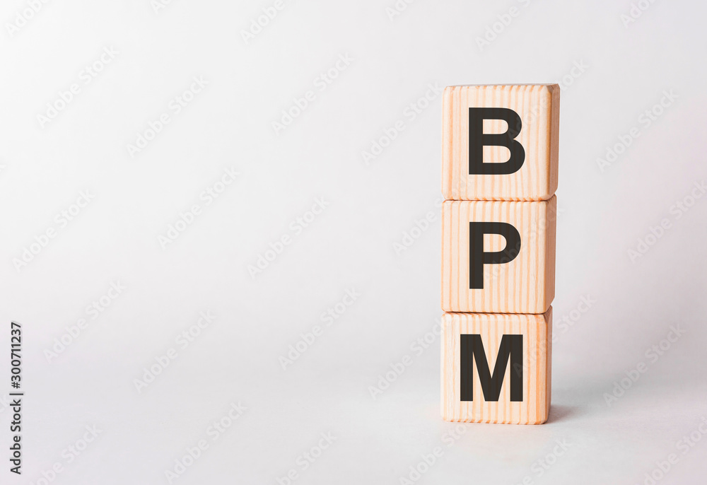 BPM letters of wooden blocks in pillar form on white background, copy space BPM letters of wooden blocks in pillar form on white background, copy space