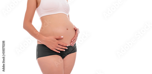 The body of a pregnant young woman on a white background.